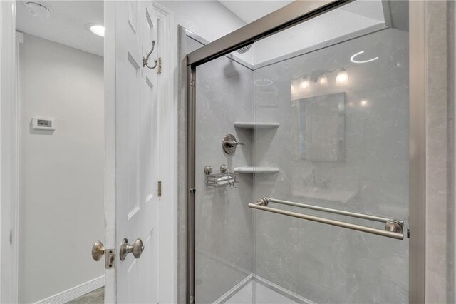 bathroom featuring a shower with shower door