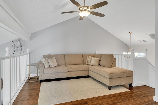 living room with lofted ceiling, dark wood-type flooring, and ceiling fan with notable chandelier