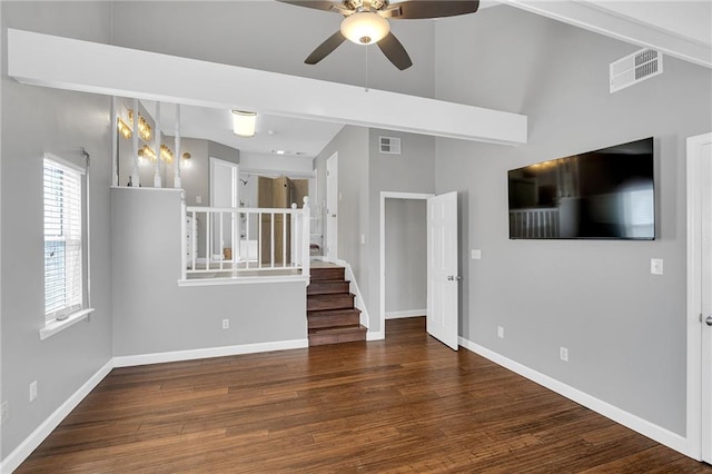 unfurnished living room with ceiling fan and dark hardwood / wood-style flooring