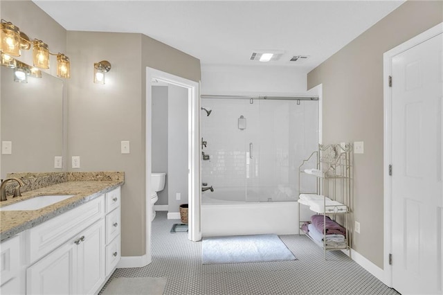 full bathroom with toilet, vanity, and shower / bath combination with glass door