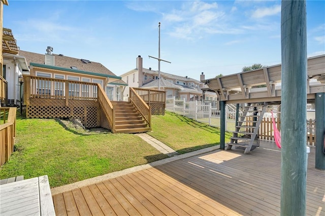 wooden terrace featuring a pergola and a lawn