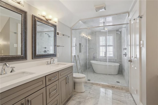 full bathroom featuring vanity, vaulted ceiling, shower with separate bathtub, and toilet