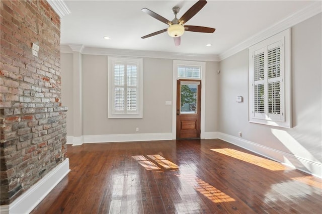 interior space with ornamental molding, dark hardwood / wood-style floors, and ceiling fan