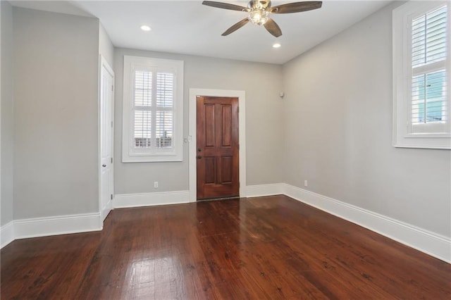 spare room with dark hardwood / wood-style floors and ceiling fan