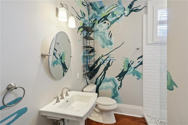 bathroom with wood-type flooring, toilet, sink, and a shower