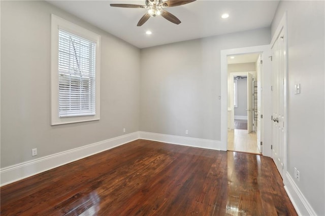 empty room with hardwood / wood-style flooring and ceiling fan