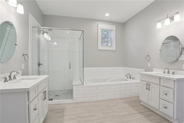 bathroom featuring independent shower and bath, vanity, and tile patterned floors