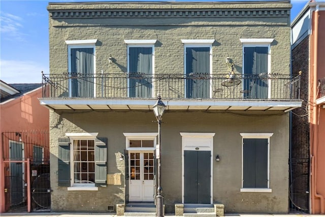 back of house featuring a balcony