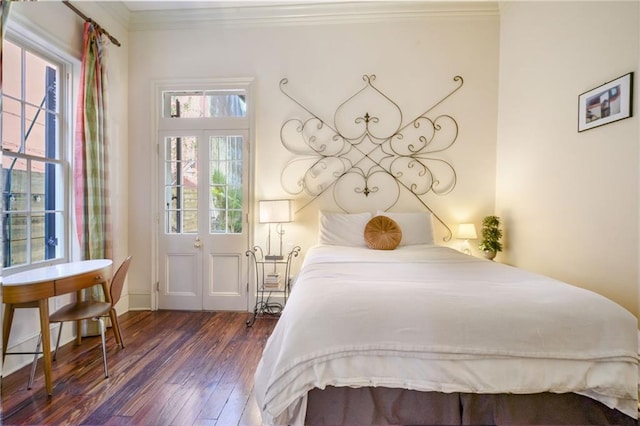 bedroom with dark wood-type flooring and ornamental molding