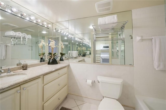 bathroom featuring vanity, tile patterned floors, and toilet