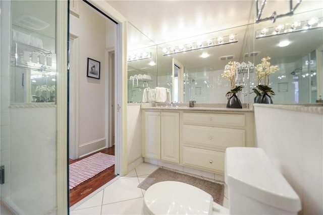 bathroom with vanity, tile patterned flooring, and a shower with shower door