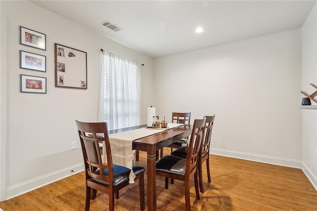 dining room with wood-type flooring