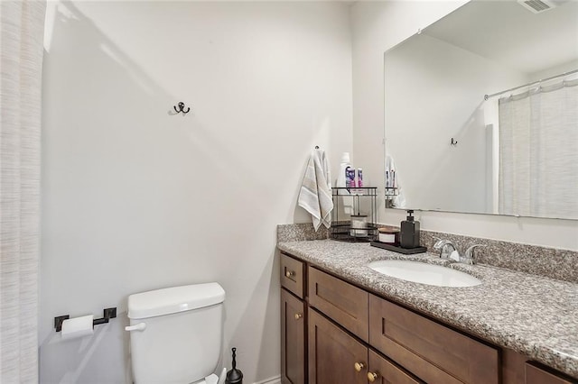 bathroom featuring vanity and toilet