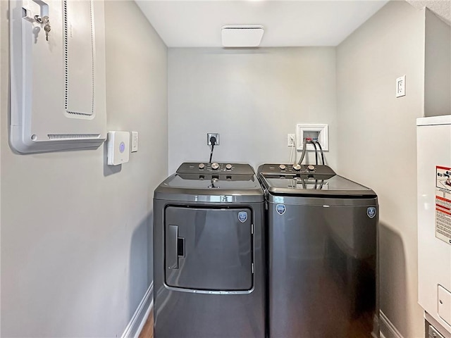 laundry area featuring hardwood / wood-style flooring and washer and dryer