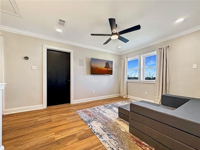 unfurnished room with crown molding, ceiling fan, and light wood-type flooring