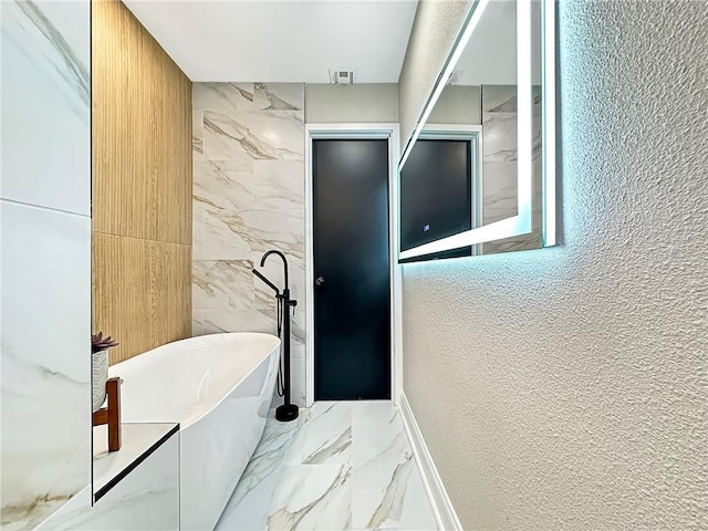 bathroom featuring tile walls and a tub