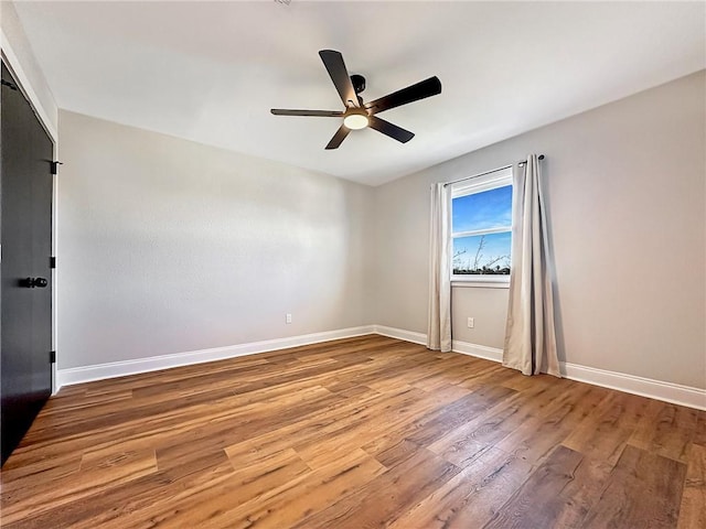 unfurnished room with hardwood / wood-style flooring and ceiling fan