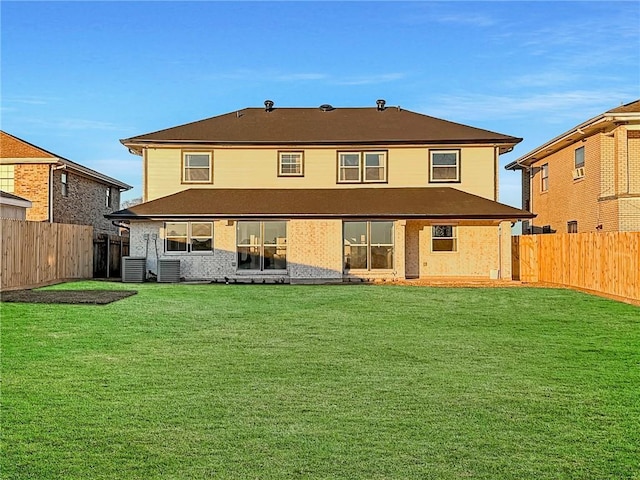 rear view of house featuring a yard and central AC