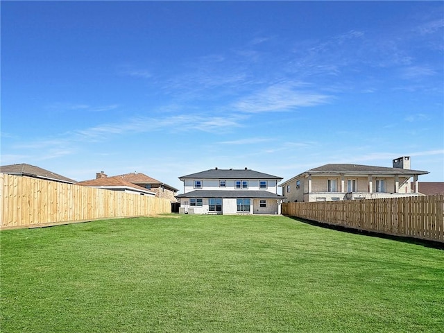 rear view of property featuring a yard