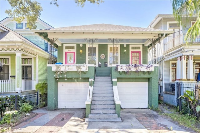 view of front of house featuring a garage and covered porch