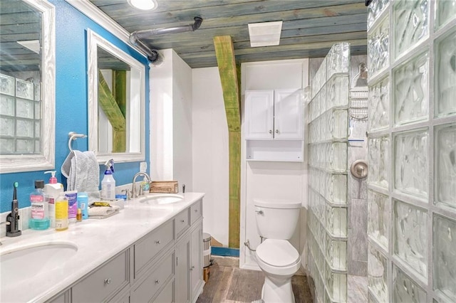 bathroom featuring hardwood / wood-style flooring, ornamental molding, toilet, and vanity