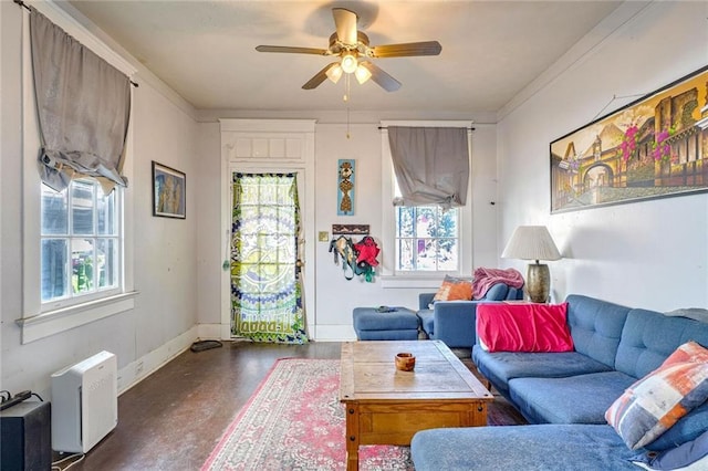 living room with ceiling fan, crown molding, and a healthy amount of sunlight