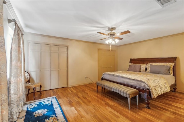 bedroom with crown molding, ceiling fan, and light hardwood / wood-style floors