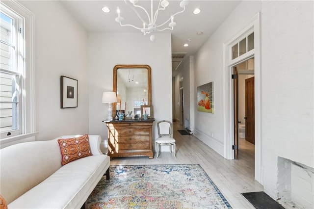 sitting room featuring light hardwood / wood-style flooring and a notable chandelier