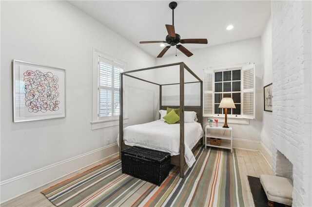 bedroom with hardwood / wood-style floors and ceiling fan