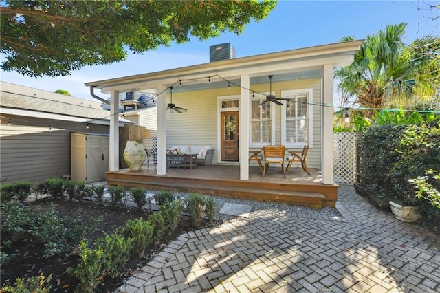 rear view of property featuring cooling unit and ceiling fan