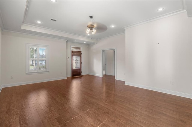 spare room featuring crown molding, dark wood-type flooring, and ceiling fan