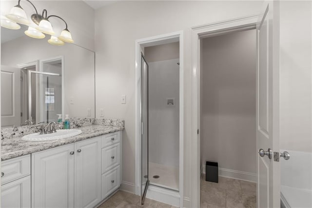 bathroom with vanity, an inviting chandelier, and walk in shower