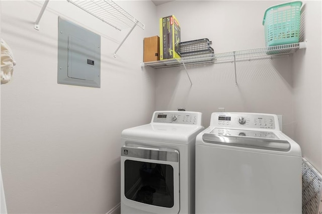 laundry room featuring washing machine and clothes dryer and electric panel