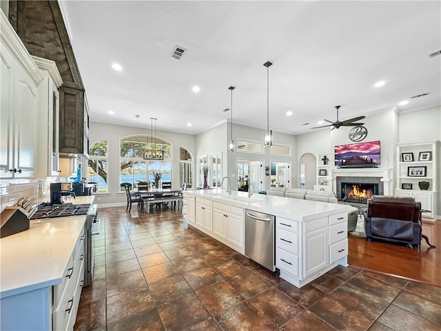 kitchen with white cabinetry, pendant lighting, stainless steel appliances, and a large island with sink