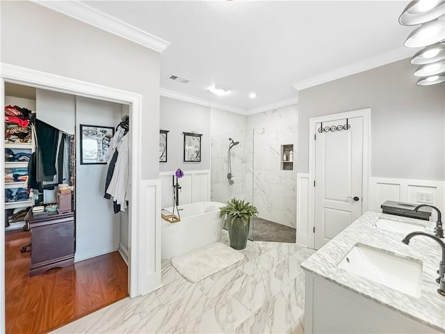 bathroom with vanity, crown molding, and shower with separate bathtub