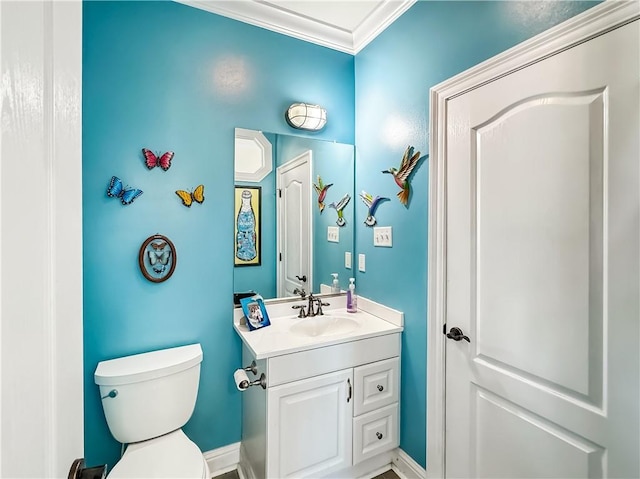 bathroom with vanity, ornamental molding, and toilet