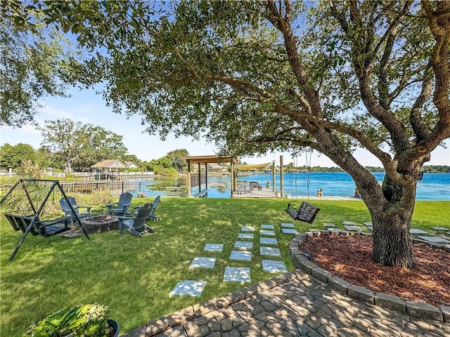 view of yard with a water view and a fire pit