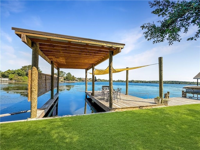 view of dock with a water view and a yard