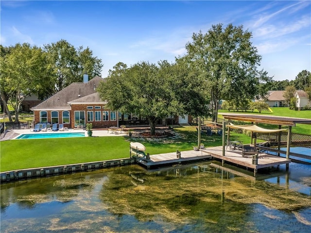 dock area with a lawn and a water view