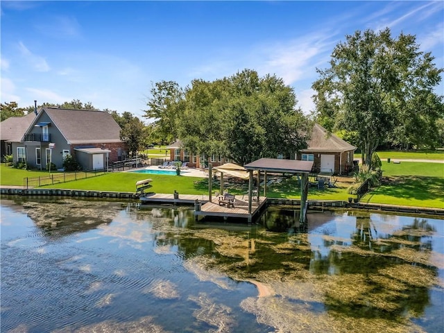 view of dock featuring a water view and a yard