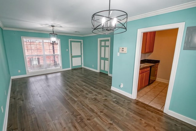 unfurnished dining area featuring crown molding, dark wood-type flooring, and a notable chandelier