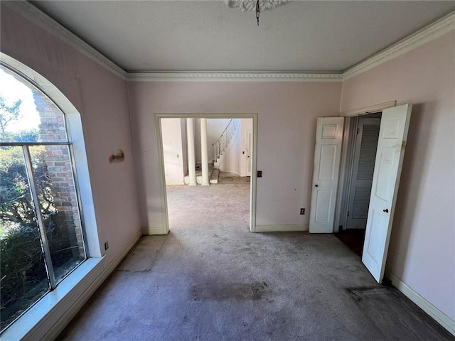 carpeted spare room with crown molding