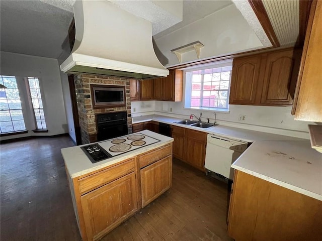 kitchen with sink, white appliances, dark hardwood / wood-style floors, a textured ceiling, and island exhaust hood