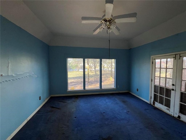 carpeted spare room with lofted ceiling, french doors, and ceiling fan