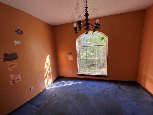 interior space featuring a chandelier and a textured ceiling