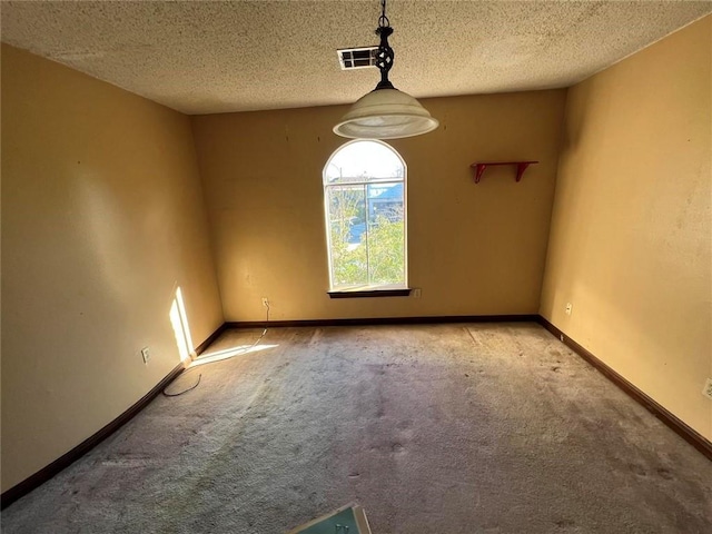 unfurnished room with light carpet and a textured ceiling