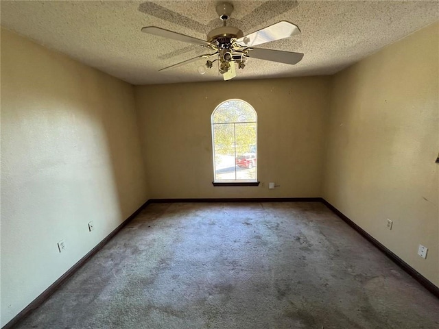 spare room featuring ceiling fan, carpet, and a textured ceiling