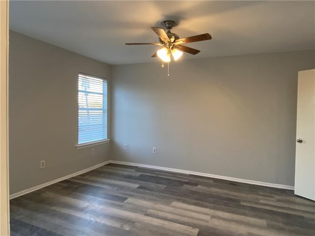 spare room with ceiling fan and dark hardwood / wood-style flooring