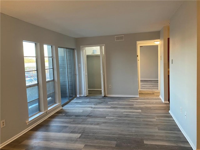 empty room with dark hardwood / wood-style floors