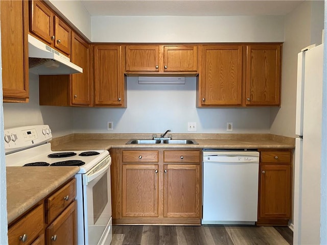 kitchen featuring sink, white appliances, and dark wood-type flooring